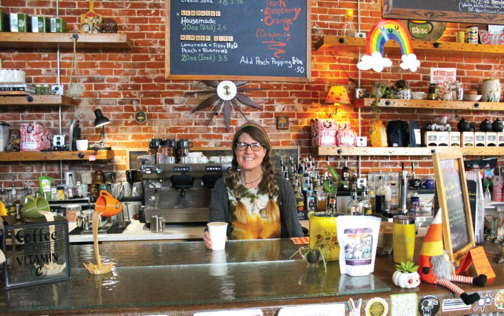 Marnie Hofmeister-Pooley behind the counter of Let's Shine Coffee shop