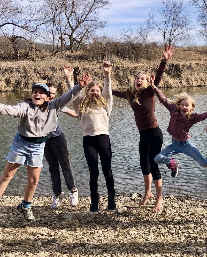 kids jumping by the river