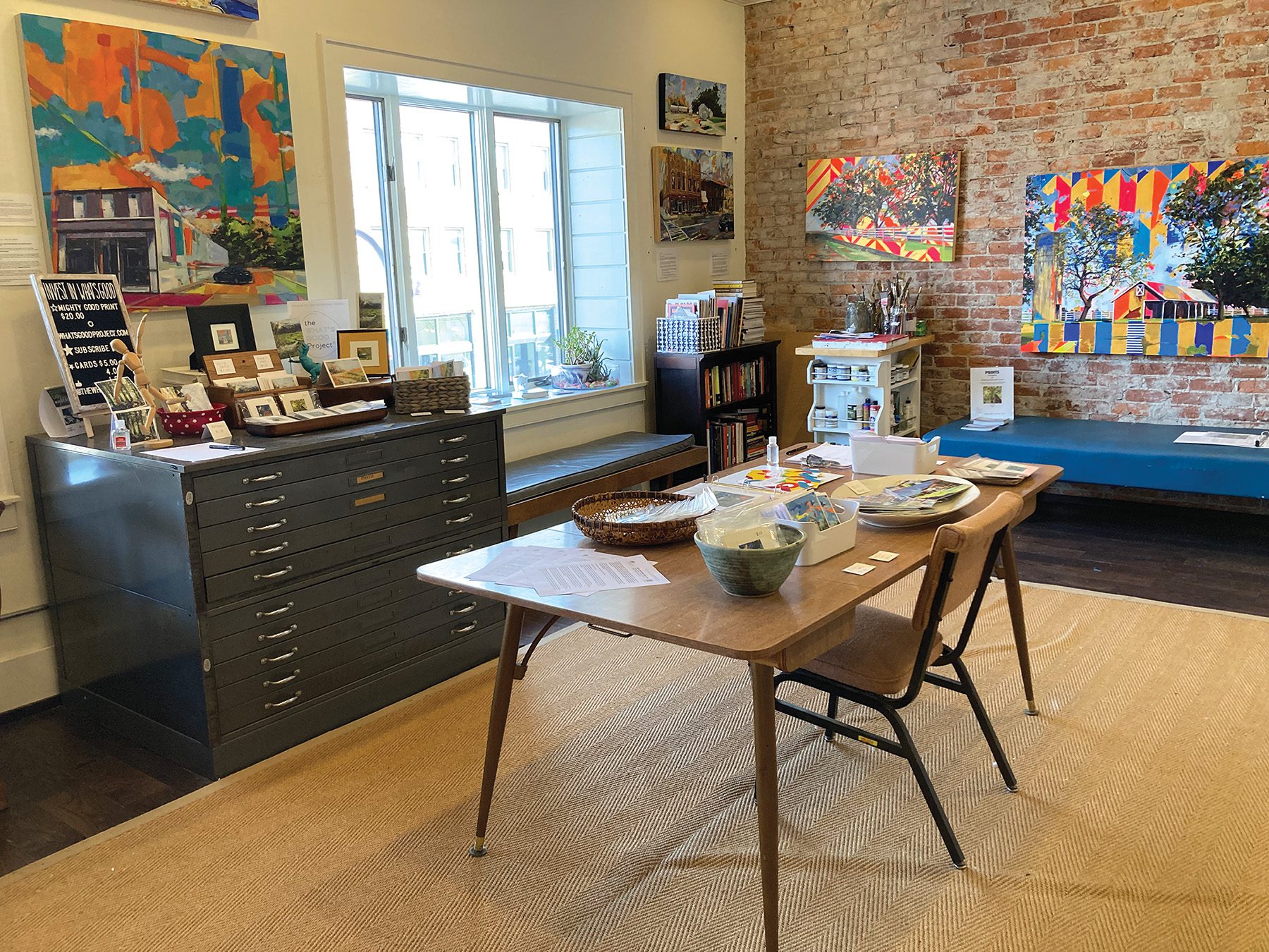 Artist Jennifer Drinkwater's art studio space with table and artwork